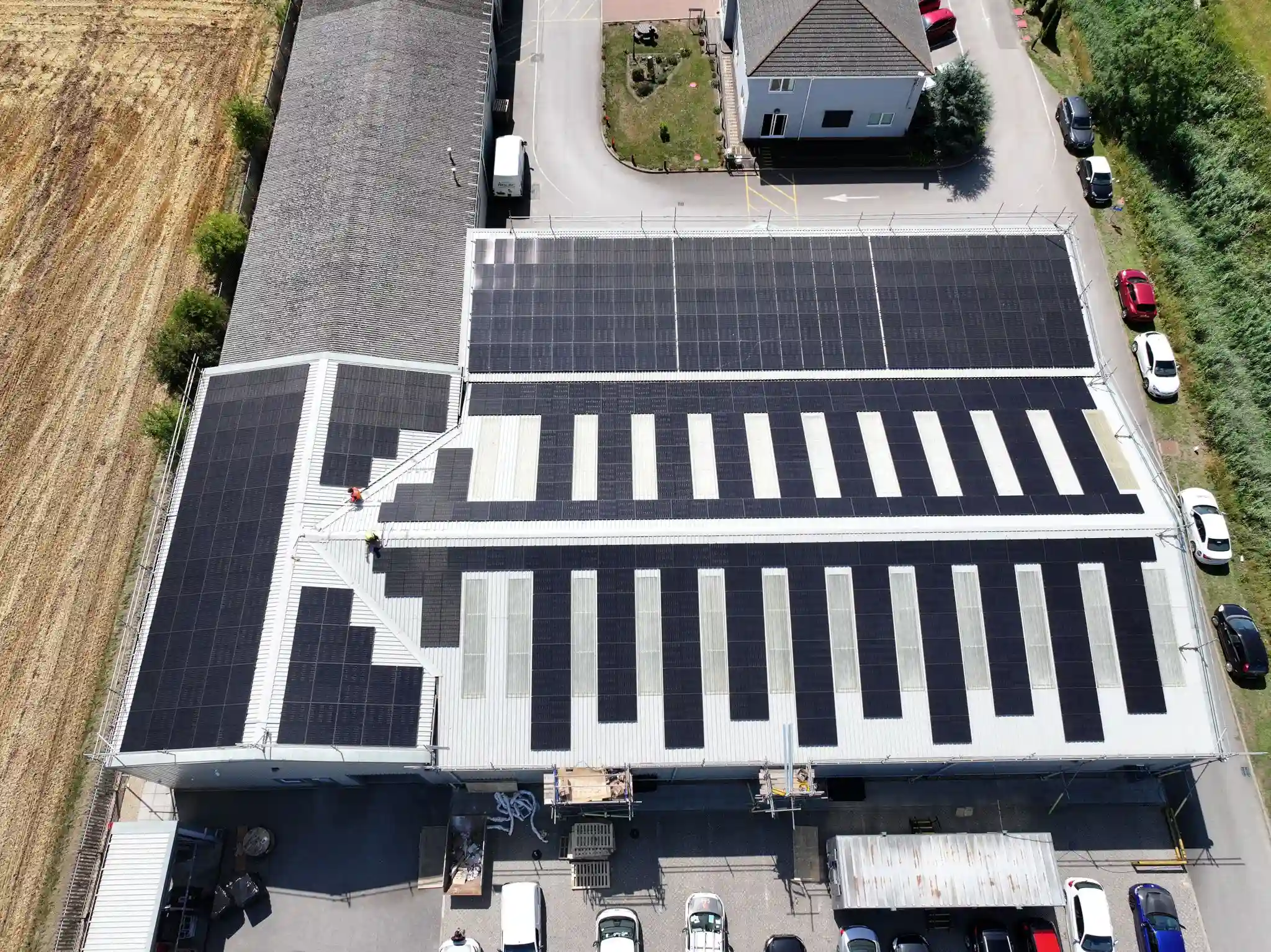 Aerial view of a commercial roof with solar panels across most of it