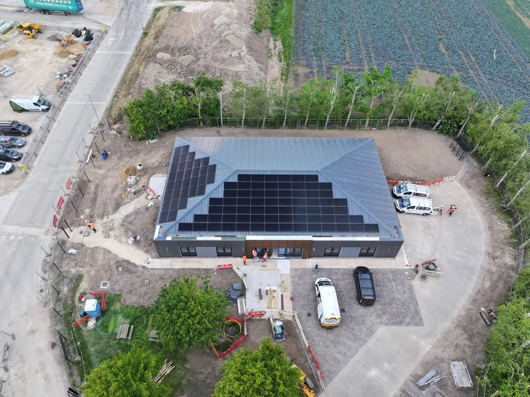 A single storey building with a newly completed solar array across its roof